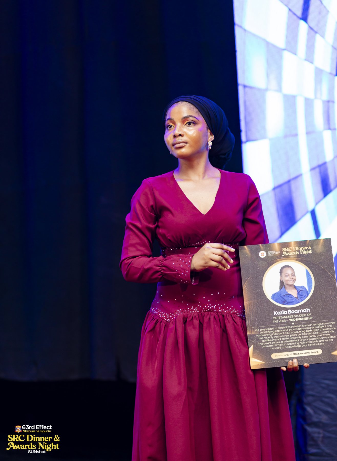 Recipient displaying a framed award